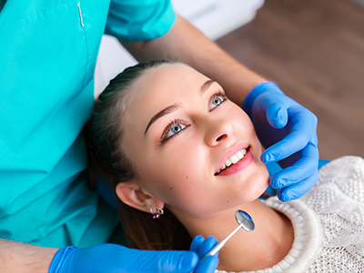 A woman receiving dental care with a professional dentist performing a procedure.